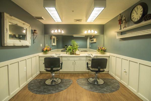 Hair salon with chair and mirrors
