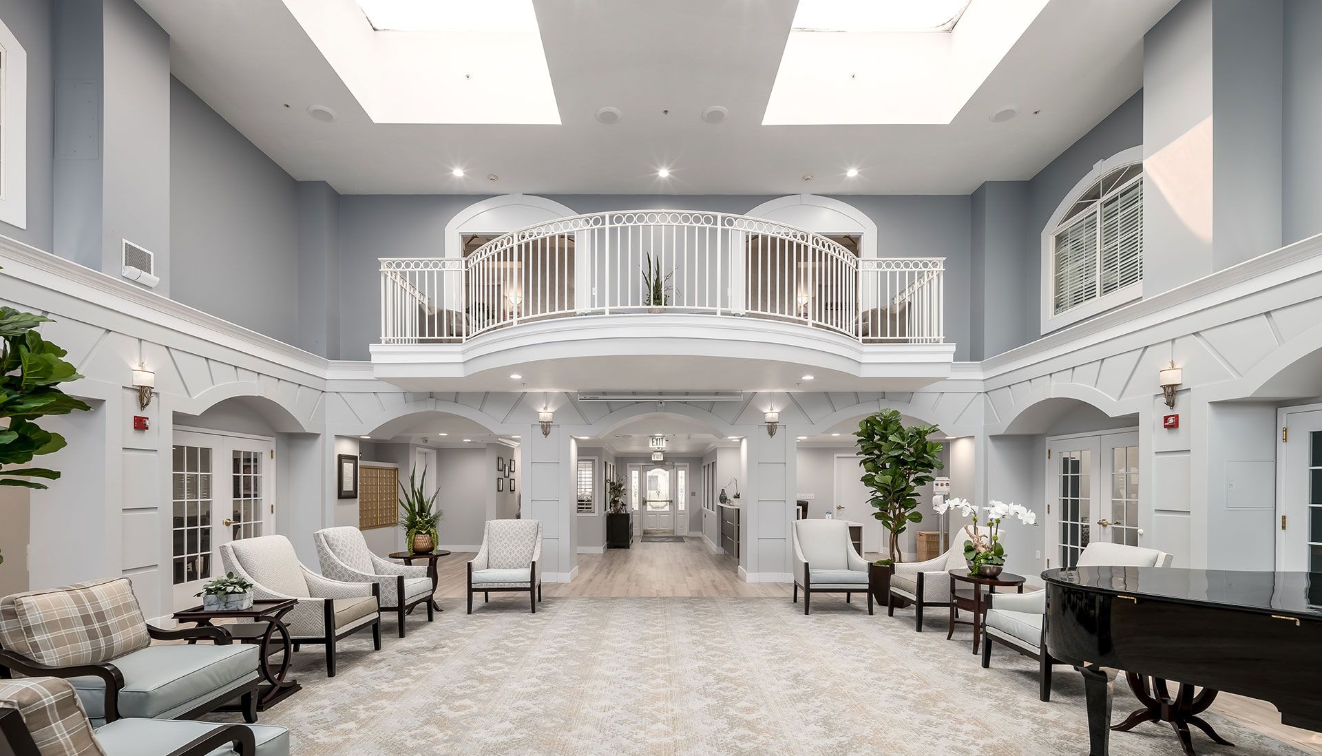 Front entrance area with a piano, balcony, and formal seating