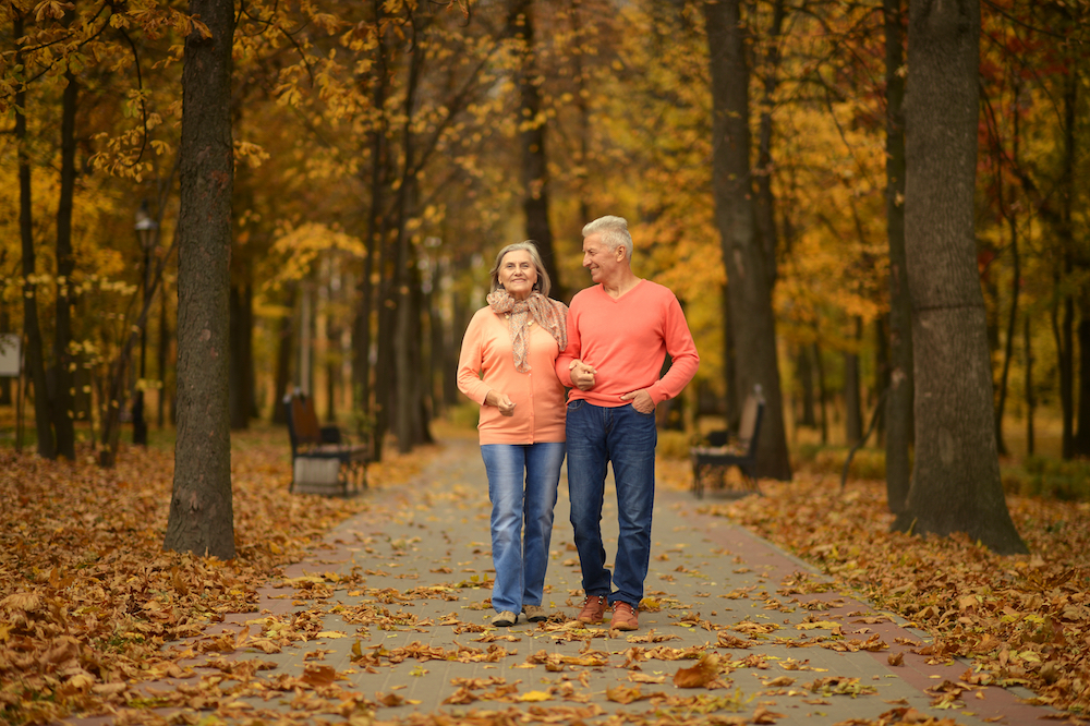 A senior couple out for a walk on a fall afternoon