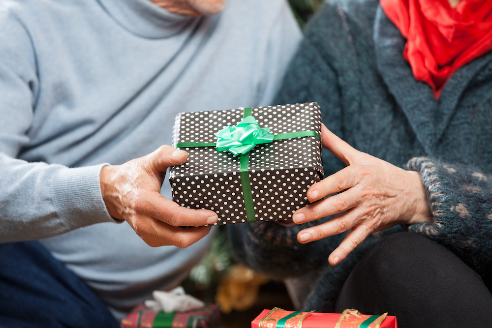 Two seniors receive a wrapped present