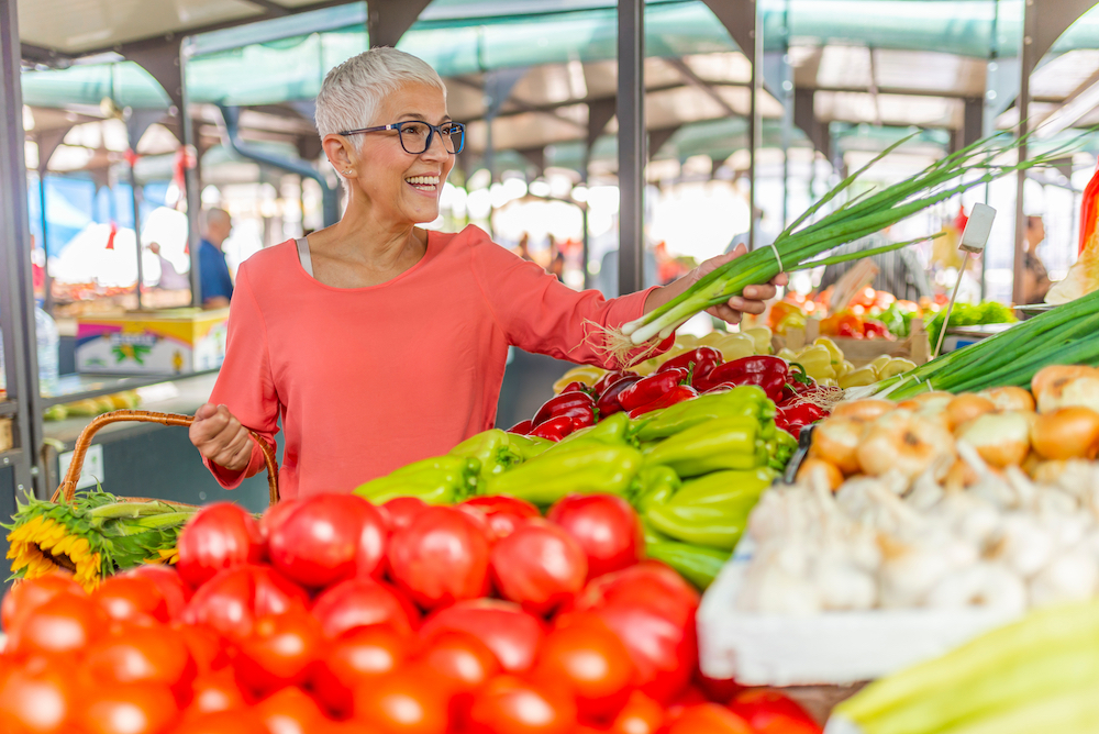 A senior woman shops out at a farmer's market