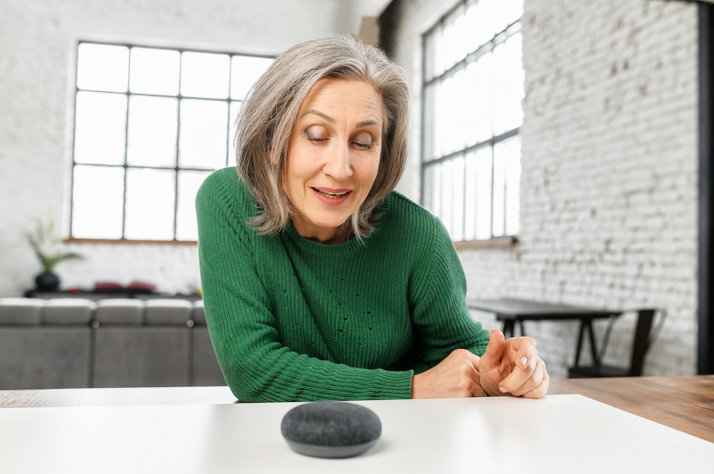 A senior woman uses her smart assistant